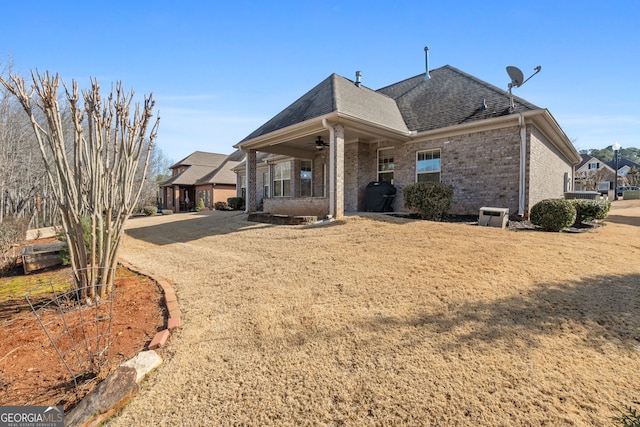 back of property with ceiling fan