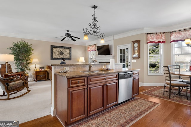 kitchen featuring dark wood-type flooring, a kitchen island with sink, dishwasher, and sink