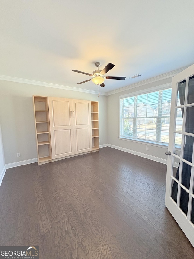 unfurnished bedroom with ceiling fan, ornamental molding, and dark hardwood / wood-style flooring