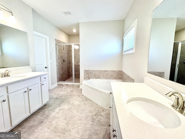 bathroom featuring vanity and independent shower and bath