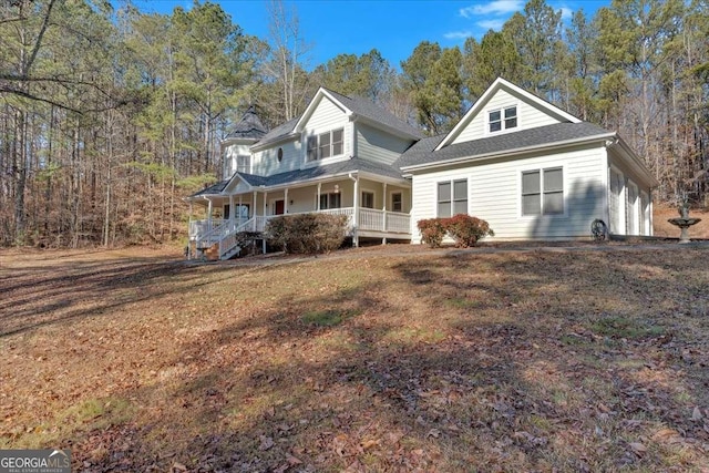 view of front of house with a porch and a front lawn