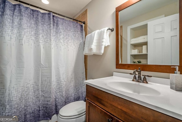 bathroom featuring vanity, a shower with shower curtain, and toilet