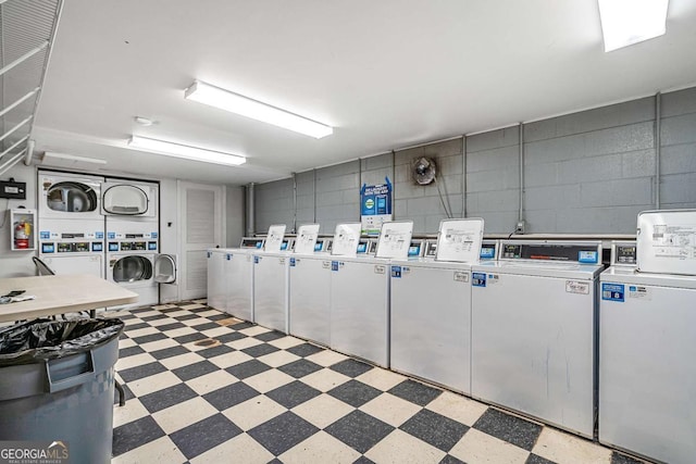 laundry area with stacked washer and dryer and washing machine and dryer