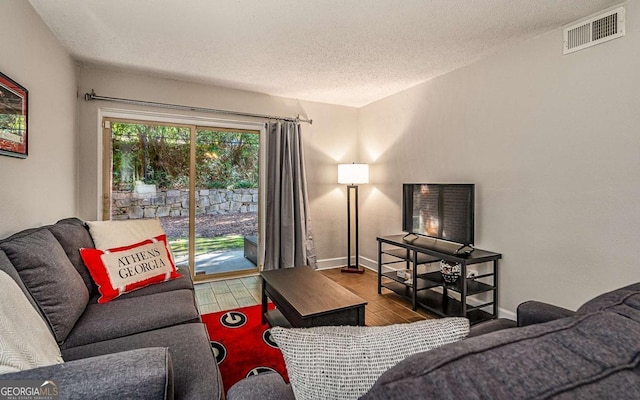 living room with hardwood / wood-style flooring and a textured ceiling