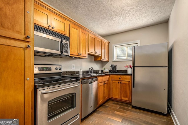 kitchen featuring sink, a textured ceiling, and appliances with stainless steel finishes