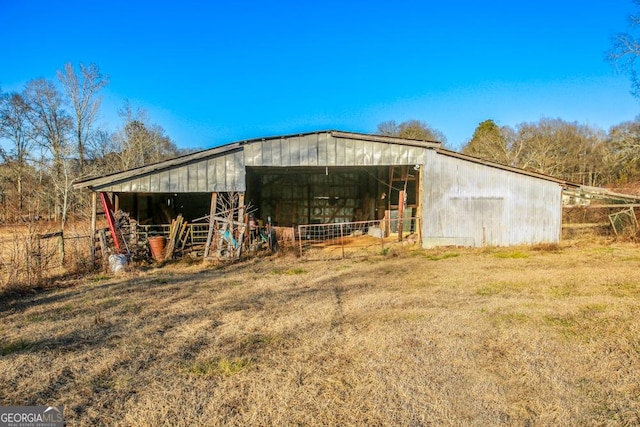 view of outbuilding featuring a lawn