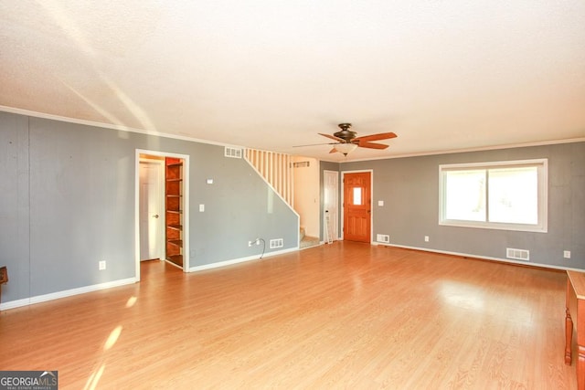 empty room featuring ceiling fan, ornamental molding, and wood-type flooring