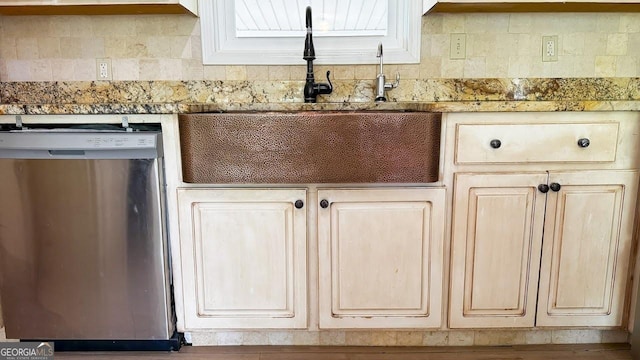 444 Agape Rd, Carrollton, GA 30116 - kitchen with stainless steel dishwasher, a sink, and light stone countertops
