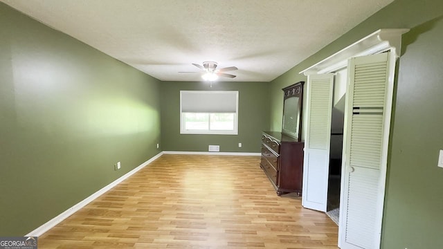 444 Agape Rd, Carrollton, GA 30116 - spare room with light wood-style floors, a ceiling fan, baseboards, and a textured ceiling