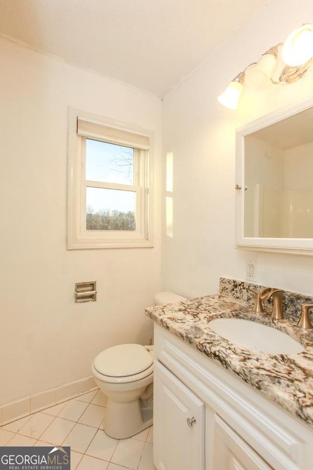 bathroom with vanity, tile patterned flooring, and toilet