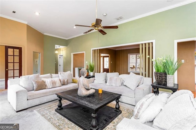 carpeted living room with ornamental molding, ceiling fan, and french doors