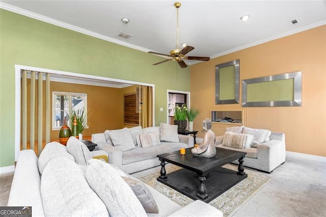 carpeted living room with crown molding and ceiling fan