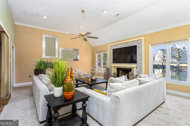 carpeted living room with crown molding, lofted ceiling, and ceiling fan