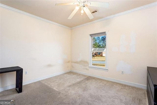 carpeted empty room featuring ornamental molding and ceiling fan