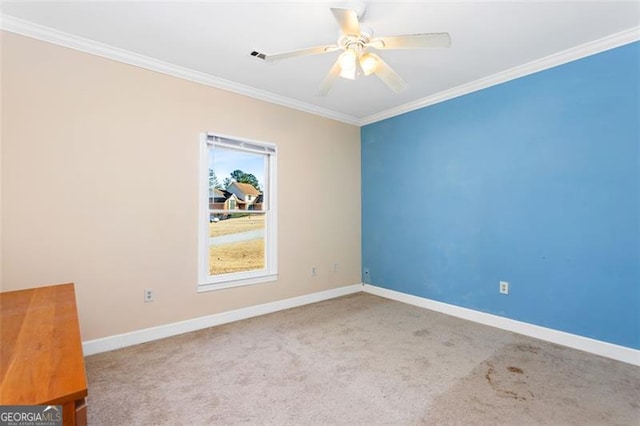 carpeted empty room with ornamental molding and ceiling fan