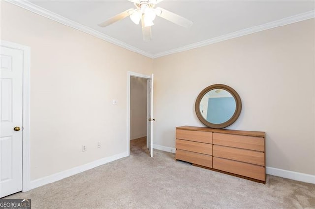 unfurnished bedroom featuring crown molding, ceiling fan, and light carpet