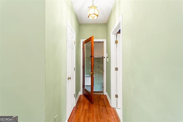 corridor with light hardwood / wood-style floors