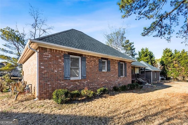 view of side of home featuring a yard