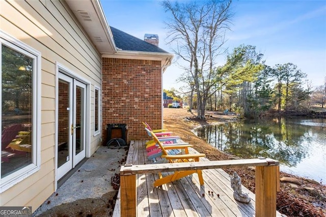 dock area featuring a deck with water view