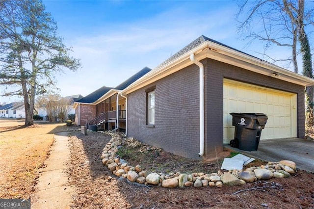 view of home's exterior with a garage and covered porch