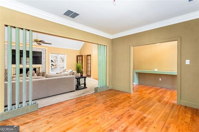 living room featuring crown molding, ceiling fan, vaulted ceiling, and light wood-type flooring