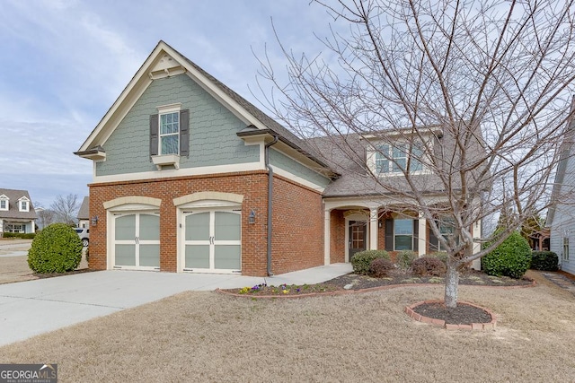 view of front of home with a garage, brick siding, and driveway