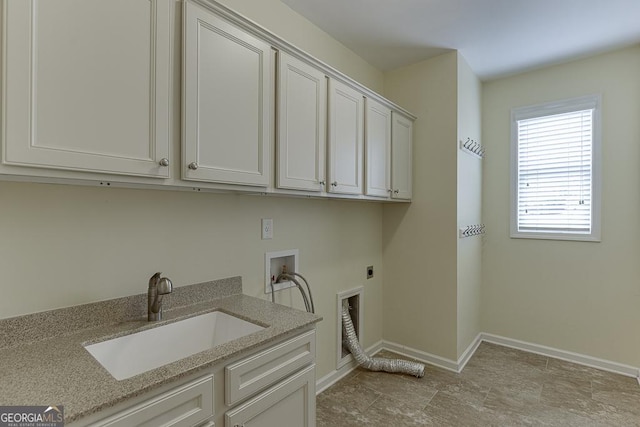 clothes washing area with cabinets, hookup for a washing machine, sink, and electric dryer hookup