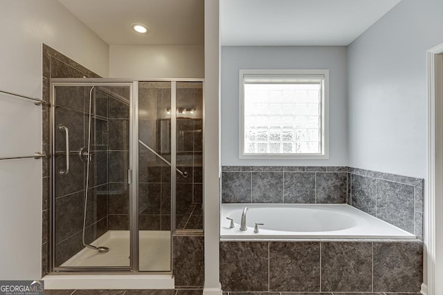 bathroom with shower with separate bathtub