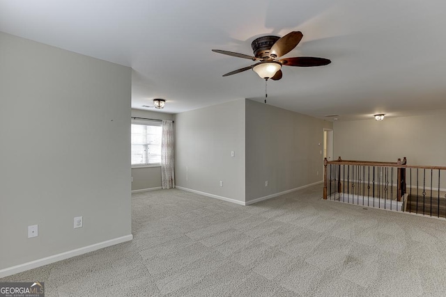 unfurnished room with ceiling fan, carpet, and baseboards