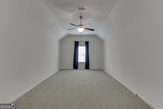 additional living space with ceiling fan, vaulted ceiling, and light carpet