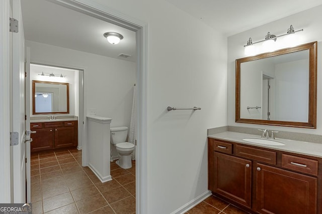 full bath featuring tile patterned flooring, toilet, visible vents, vanity, and baseboards