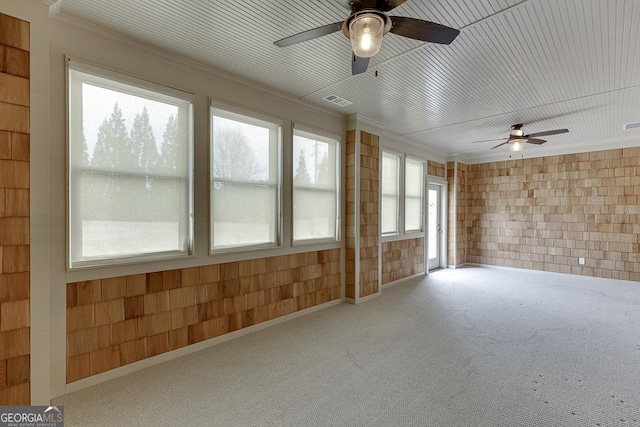 interior space featuring ceiling fan and ornamental molding