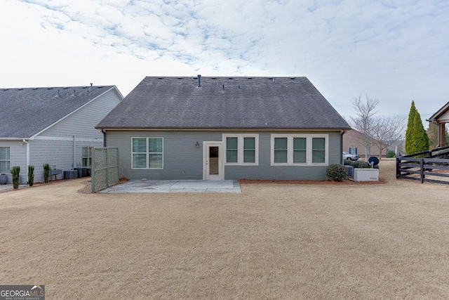 rear view of property featuring cooling unit and a patio area