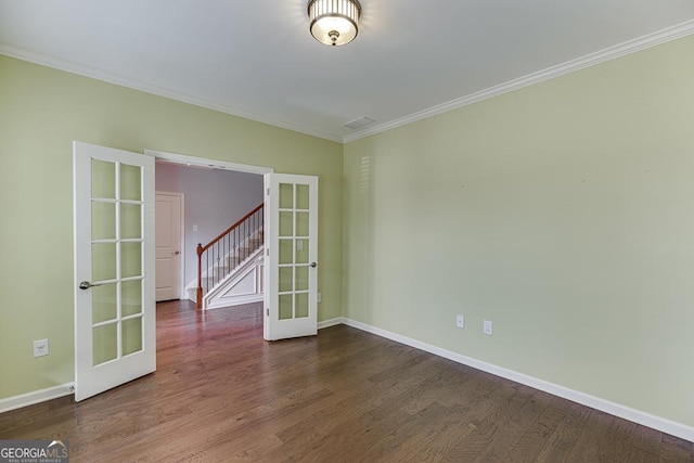 spare room featuring crown molding, hardwood / wood-style floors, and french doors