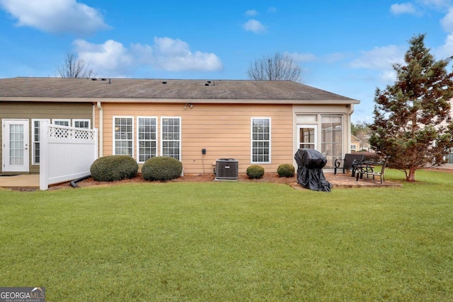 rear view of property featuring central AC, a lawn, and a patio area