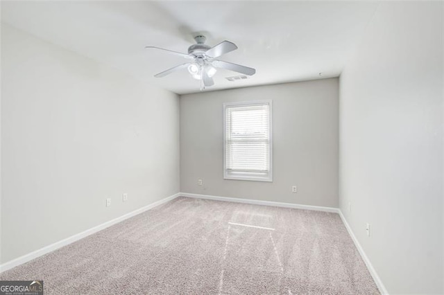 unfurnished room with ceiling fan and light carpet