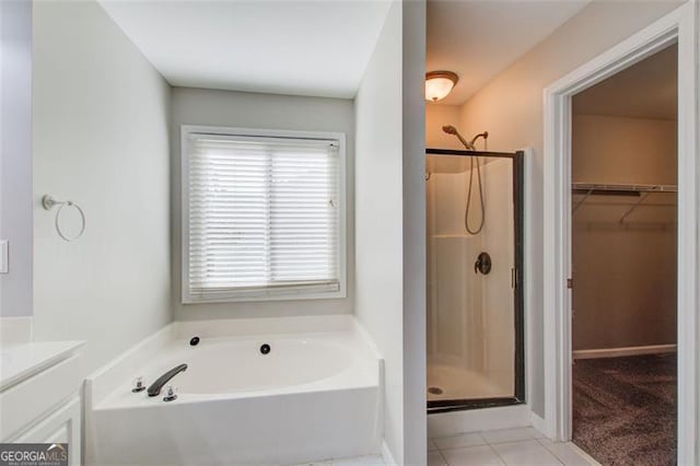 bathroom with tile patterned floors and separate shower and tub