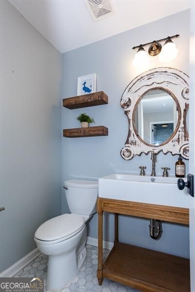 bathroom with lofted ceiling and toilet