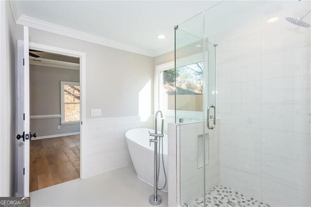 bathroom with tile walls, tile patterned floors, ornamental molding, and separate shower and tub