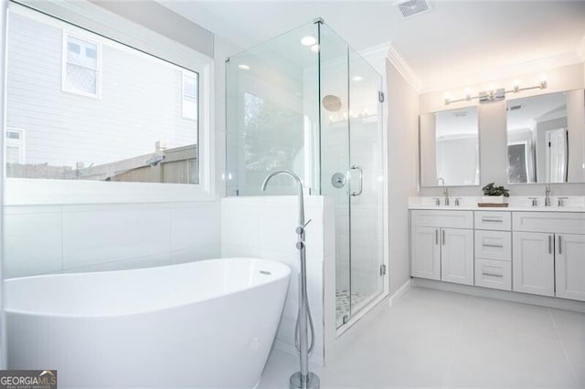 bathroom with tile patterned flooring, vanity, ornamental molding, and plus walk in shower