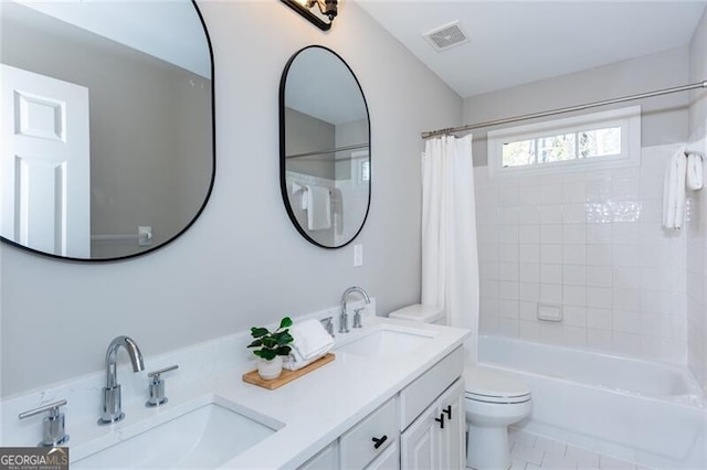 full bathroom with vanity, shower / tub combo, and toilet