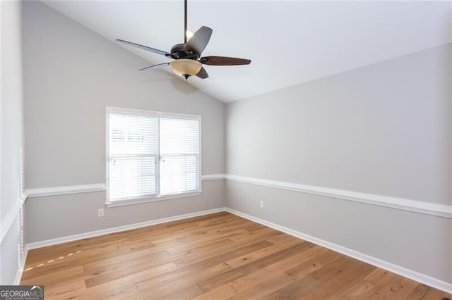 spare room with vaulted ceiling, light hardwood / wood-style floors, and ceiling fan