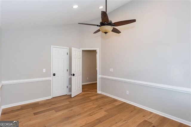 empty room featuring vaulted ceiling, ceiling fan, and light hardwood / wood-style floors