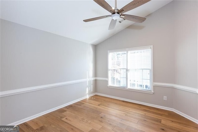 unfurnished room featuring light hardwood / wood-style flooring, ceiling fan, and vaulted ceiling