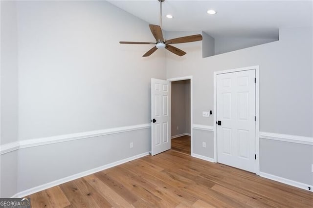 unfurnished bedroom with lofted ceiling, ceiling fan, and light hardwood / wood-style flooring