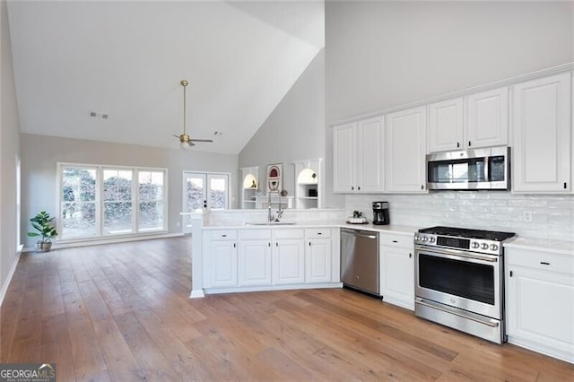 kitchen with white cabinetry, ceiling fan, appliances with stainless steel finishes, and kitchen peninsula