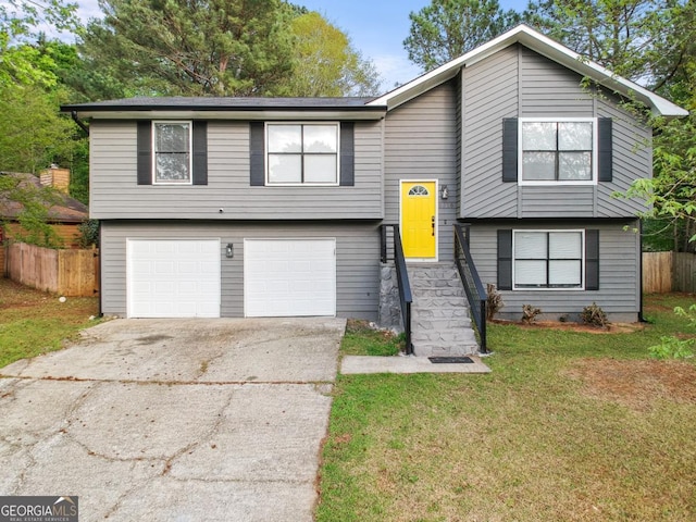 bi-level home with a garage and a front yard