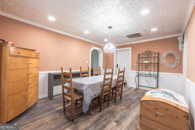 dining area featuring ornamental molding and dark hardwood / wood-style floors