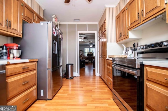 kitchen with ceiling fan, appliances with stainless steel finishes, ornamental molding, light hardwood / wood-style floors, and a baseboard radiator