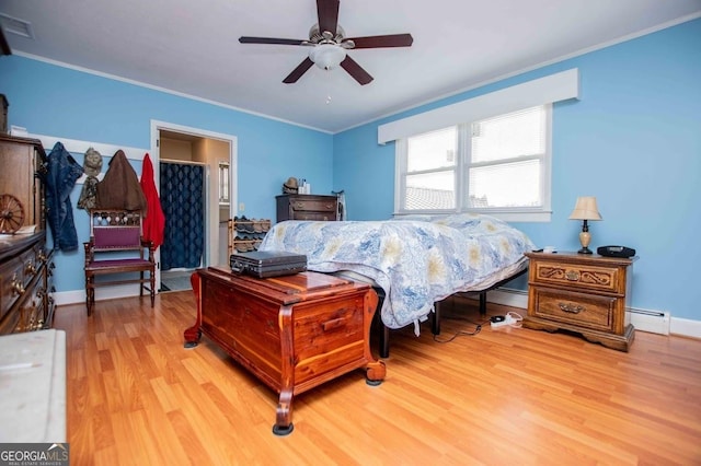 bedroom with ornamental molding, light hardwood / wood-style floors, ceiling fan, and baseboard heating